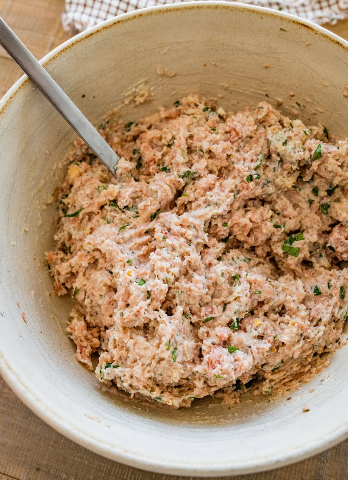 Ingredients for ricotta meatballs mixed in a bowl.