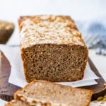 sourdough rye bread recipe after baking it on cooling rack. One slice taken out of the bread.