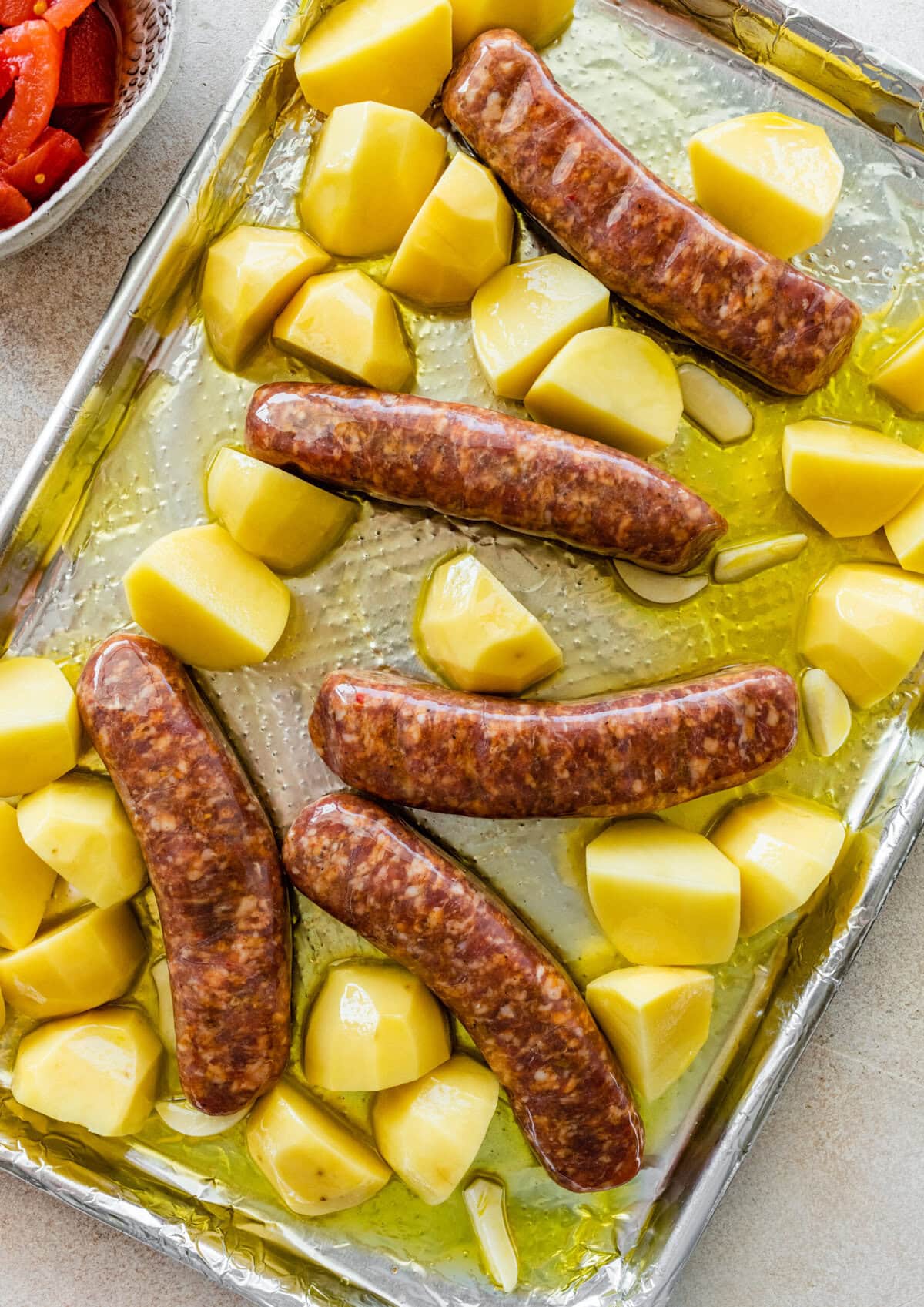 Sausages are added to the pan with the potatoes.
