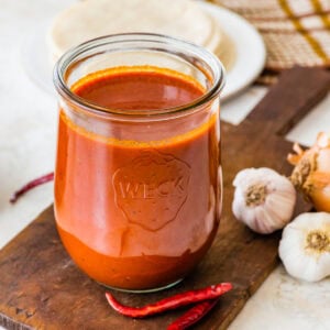 Homemade red enchilada sauce in a glass jar.