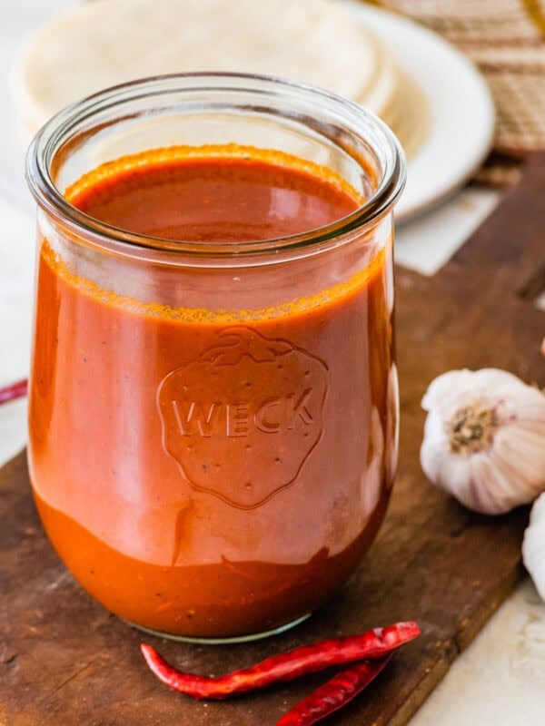 Homemade red enchilada sauce in a glass jar.