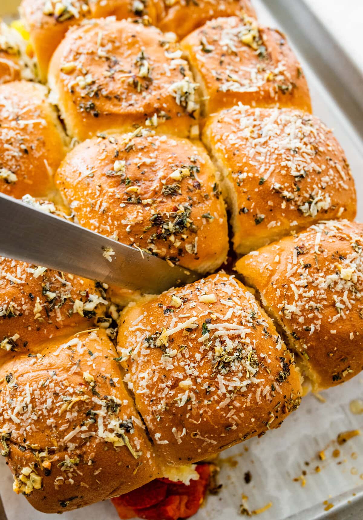 knife cutting the Italian sliders.