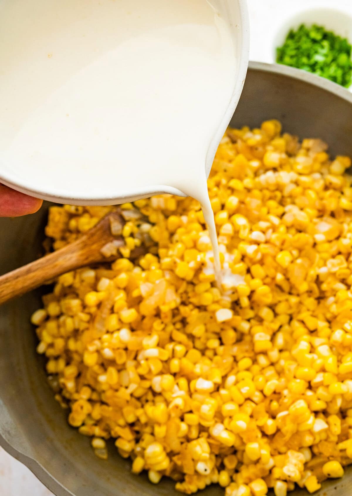 Add the milk mixture to the pan with seasoned cooked corn.