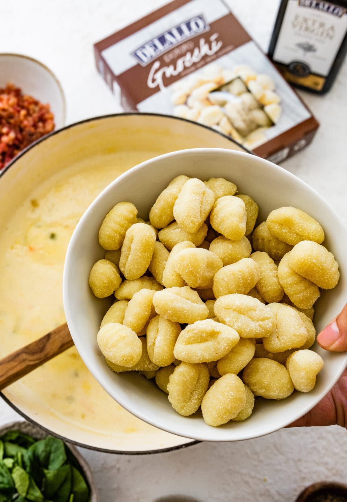 adding the gnocchi to the creamy gnocchi soup recipe.