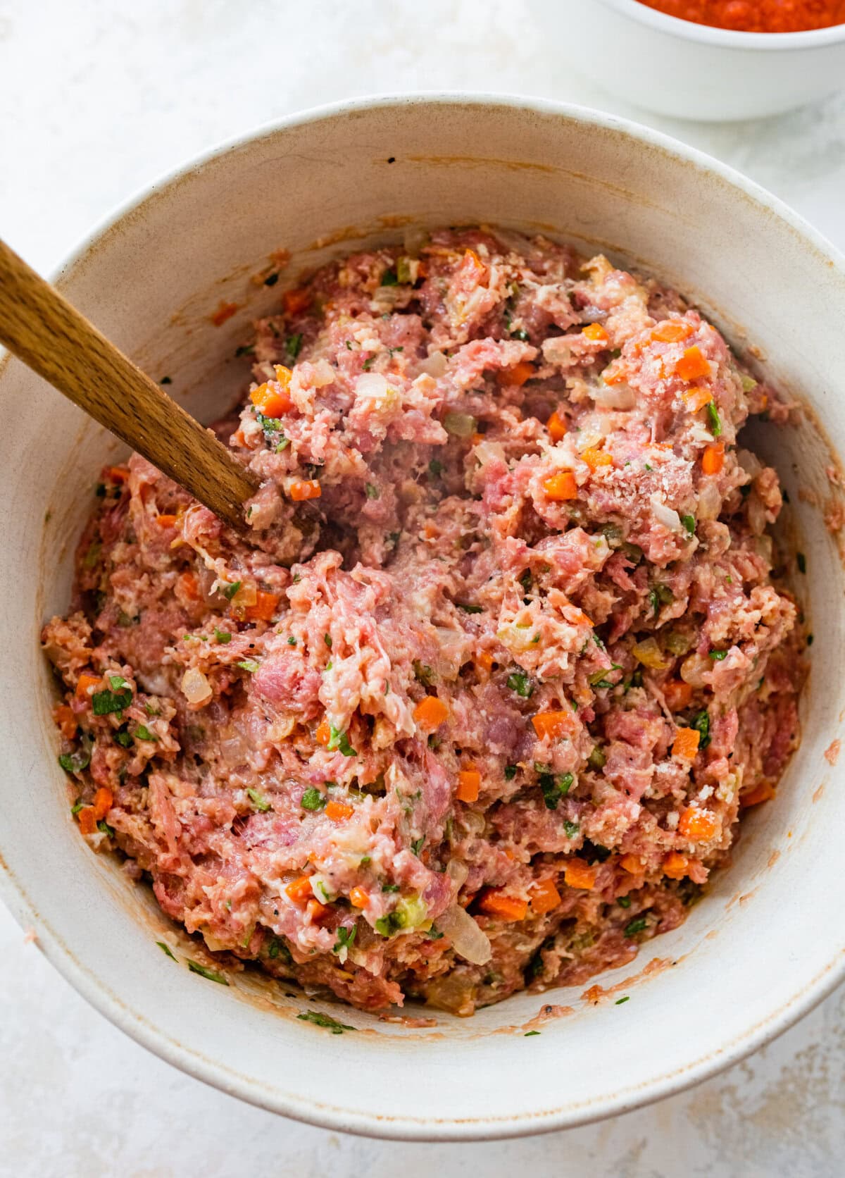 mix all the ingredients for Italian meatloaf in a bowl until fully combined.