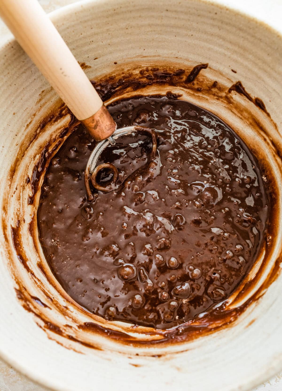 bowl with whisk and brownie batter.