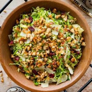 shaved brussels sprouts salad in a wooden salad bowl ready to serve.