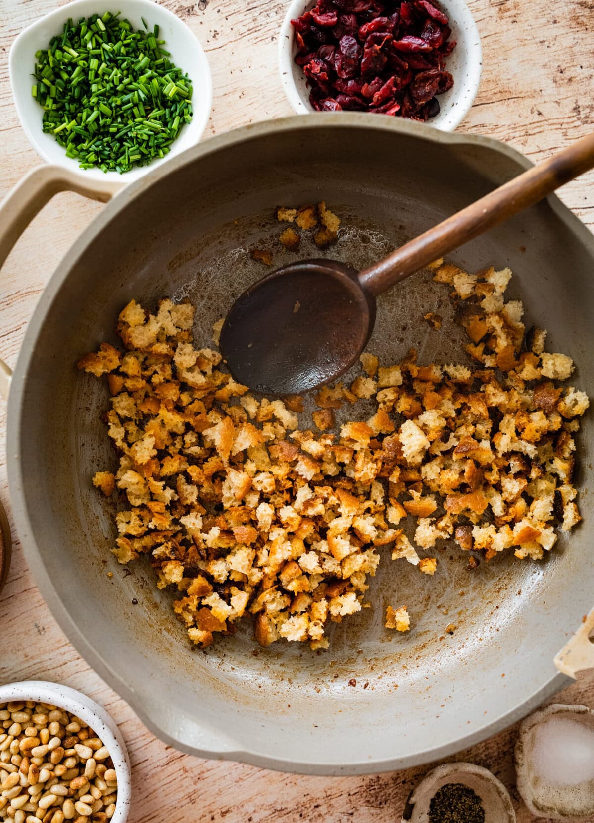 breadcrumbs toasting in a pan.