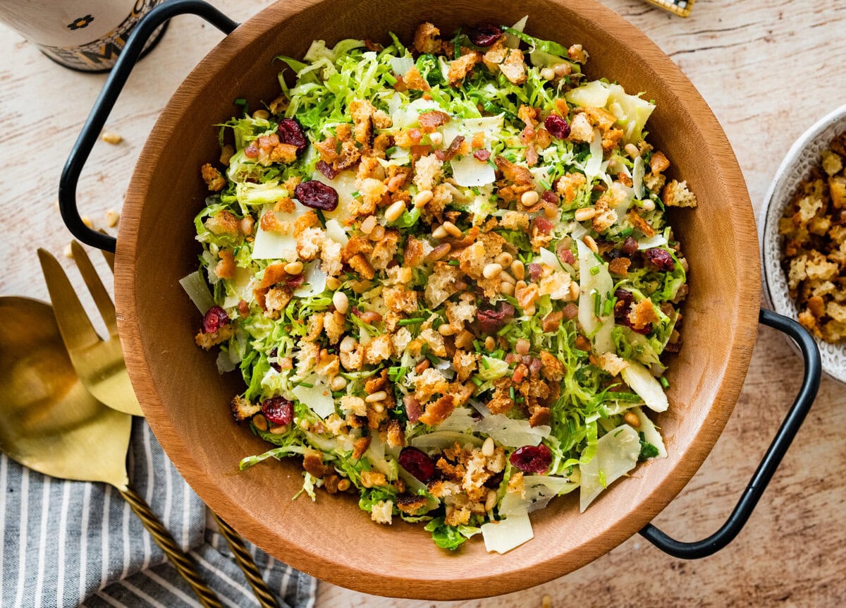shaved brussels sprouts salad in a wooden salad bowl ready to serve.