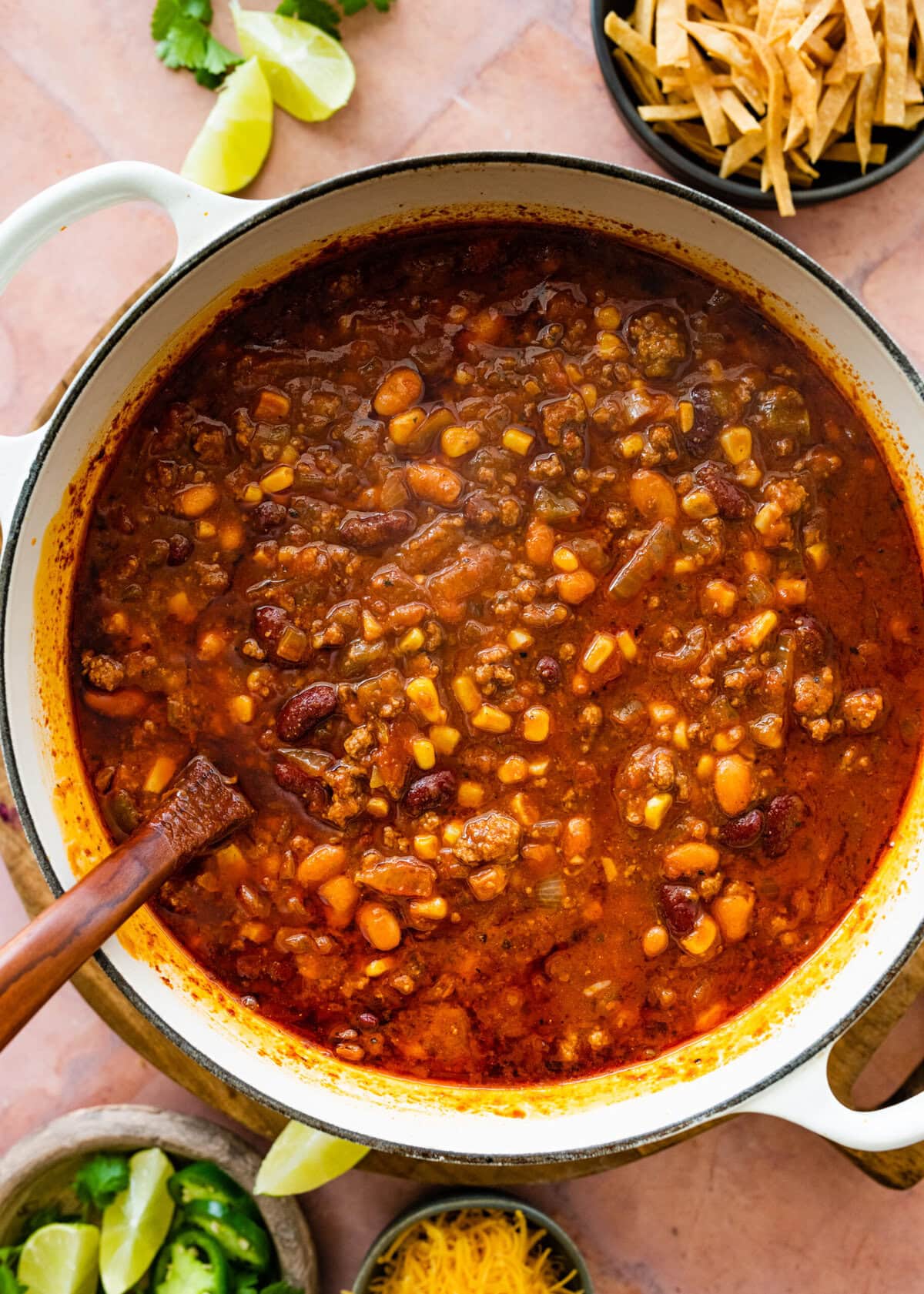 cooked taco soup in a soup pot with a wooden spoon in it.
