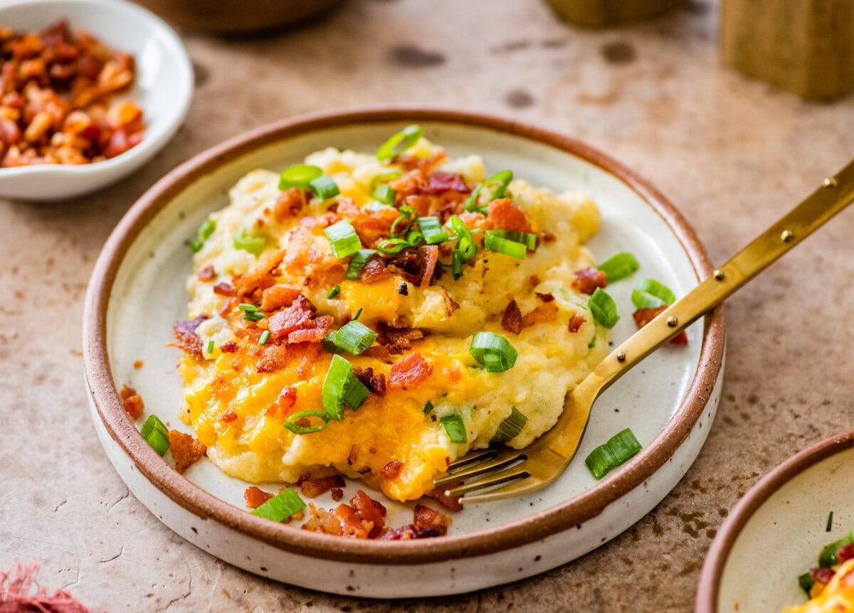 plate with a serving of twice baked potato casserole and a for to eat it with.