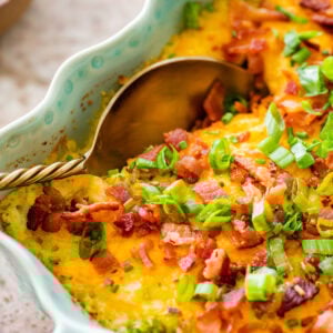 casserole of twice baked potato with a serving spoon in it.
