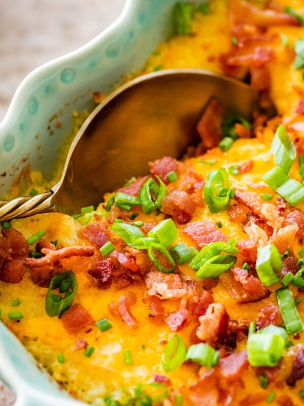 casserole of twice baked potato with a serving spoon in it.