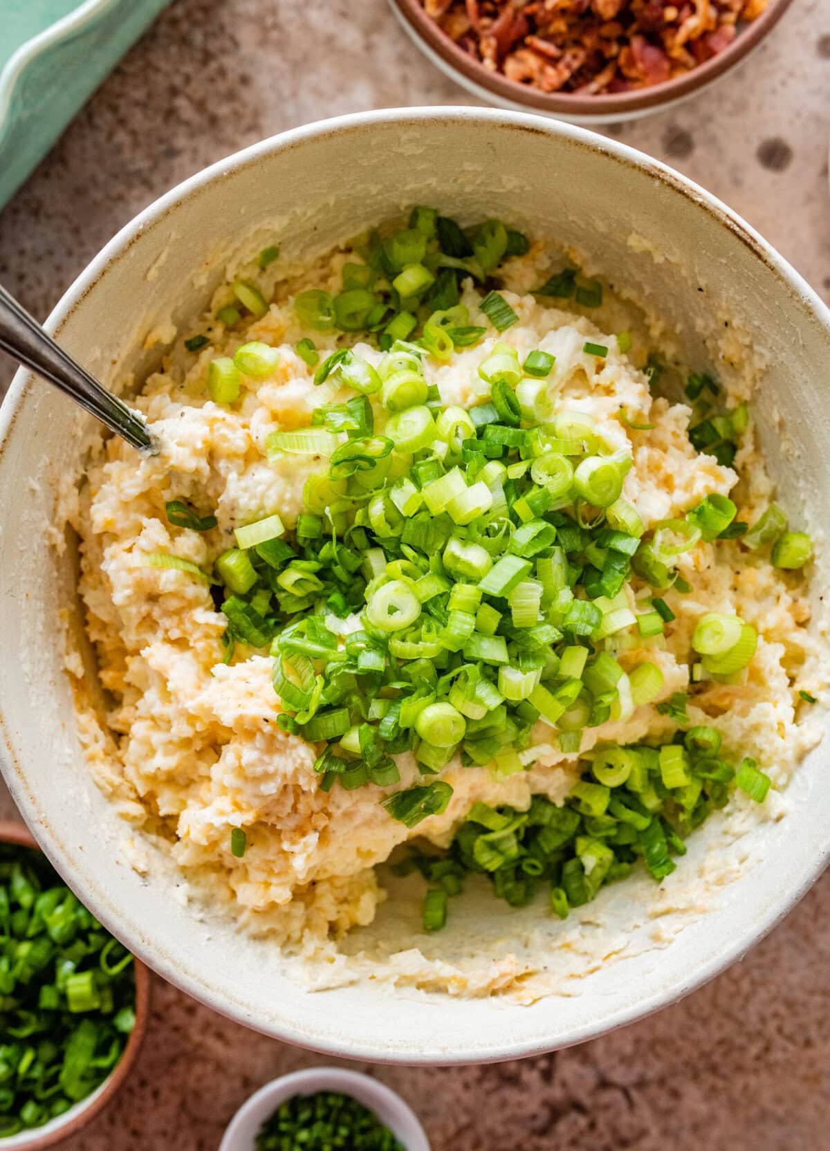 all the ingredients for the twice baked potatoes in a bowl and mixed together.