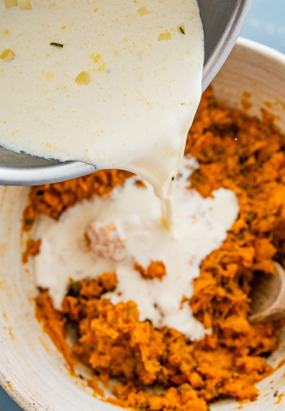 pouring cream and onion mixture on top of the sweet potatoes.