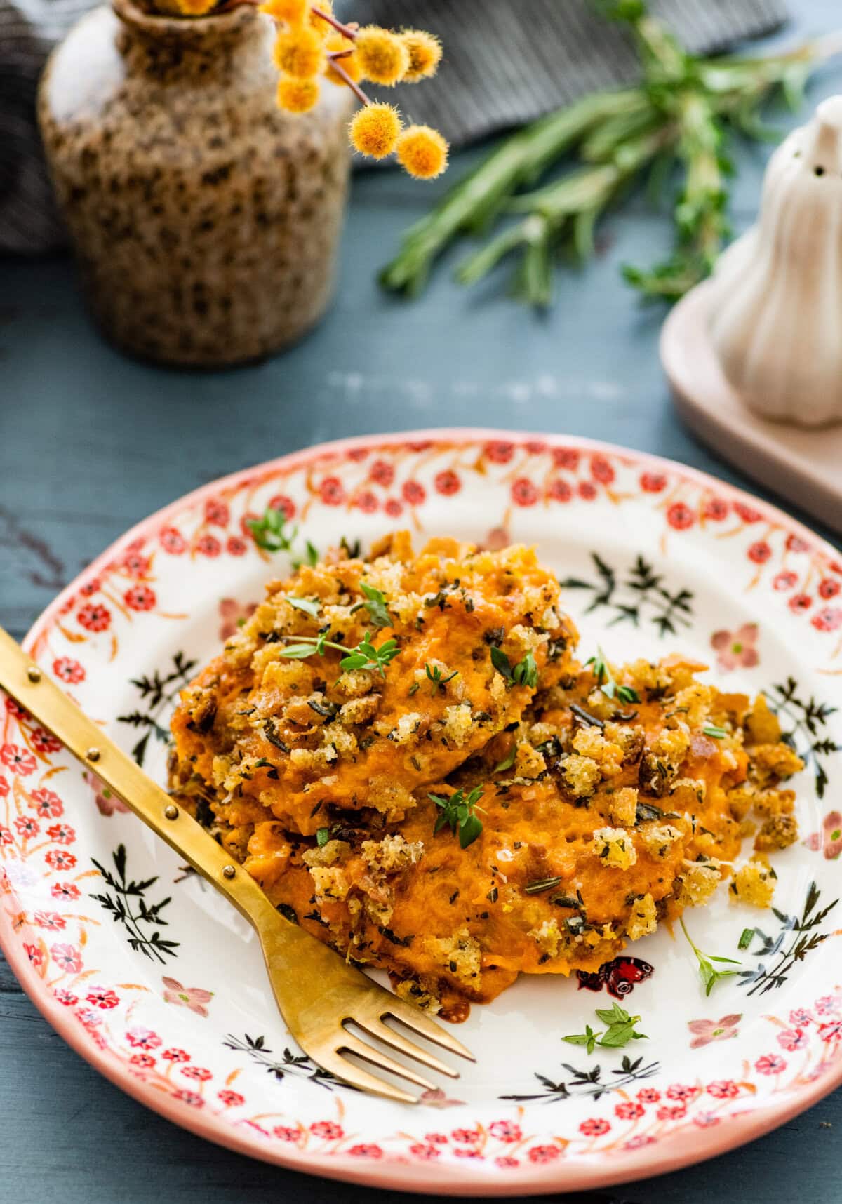 savory sweet potatoes on a plate with a fork.