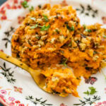 savory sweet potatoes on a plate with a fork.