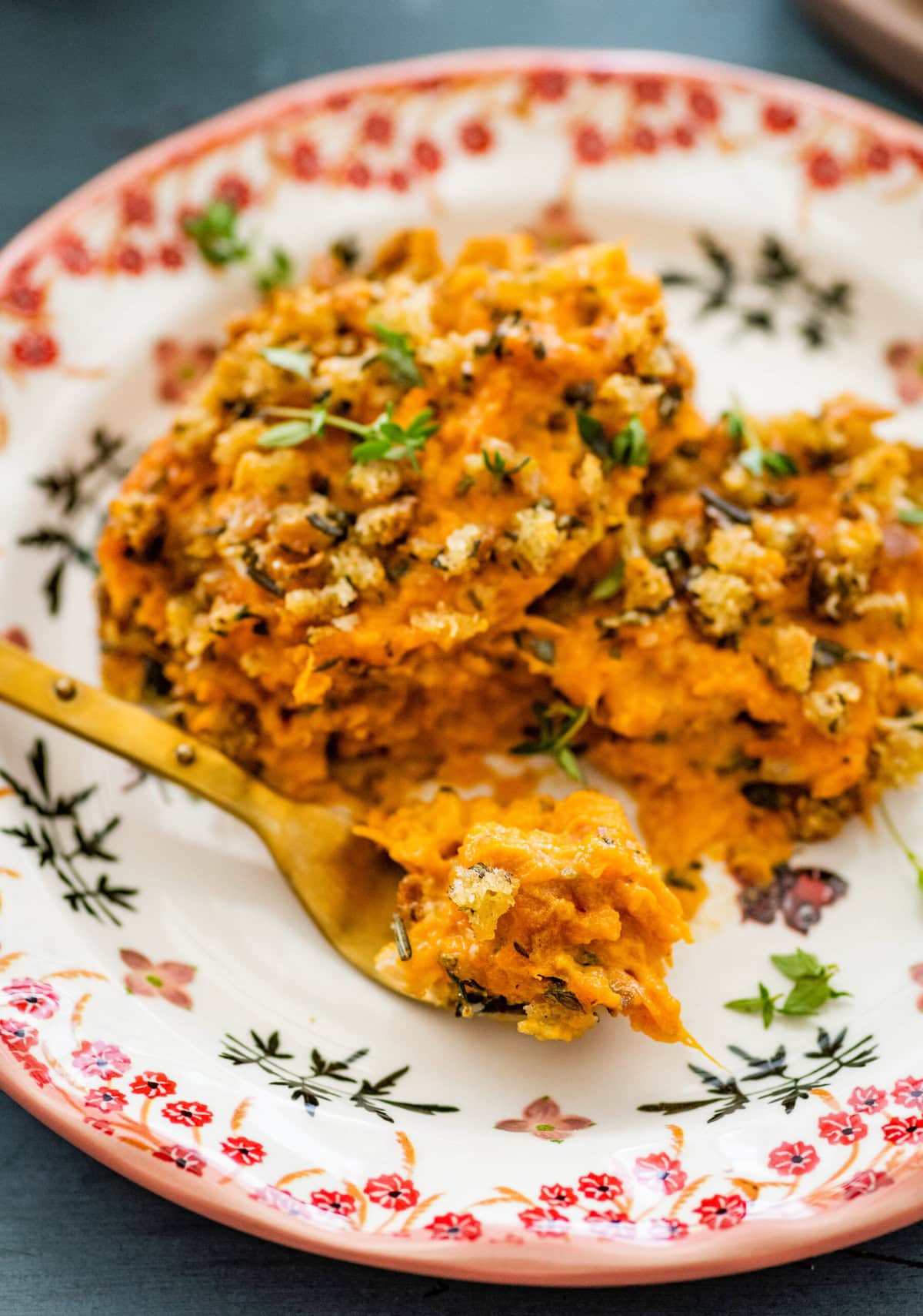savory sweet potatoes on a plate with a fork.