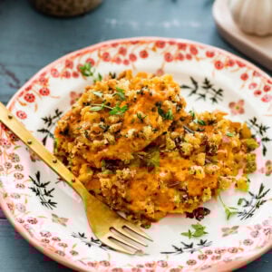 savory sweet potatoes on a plate with a fork.