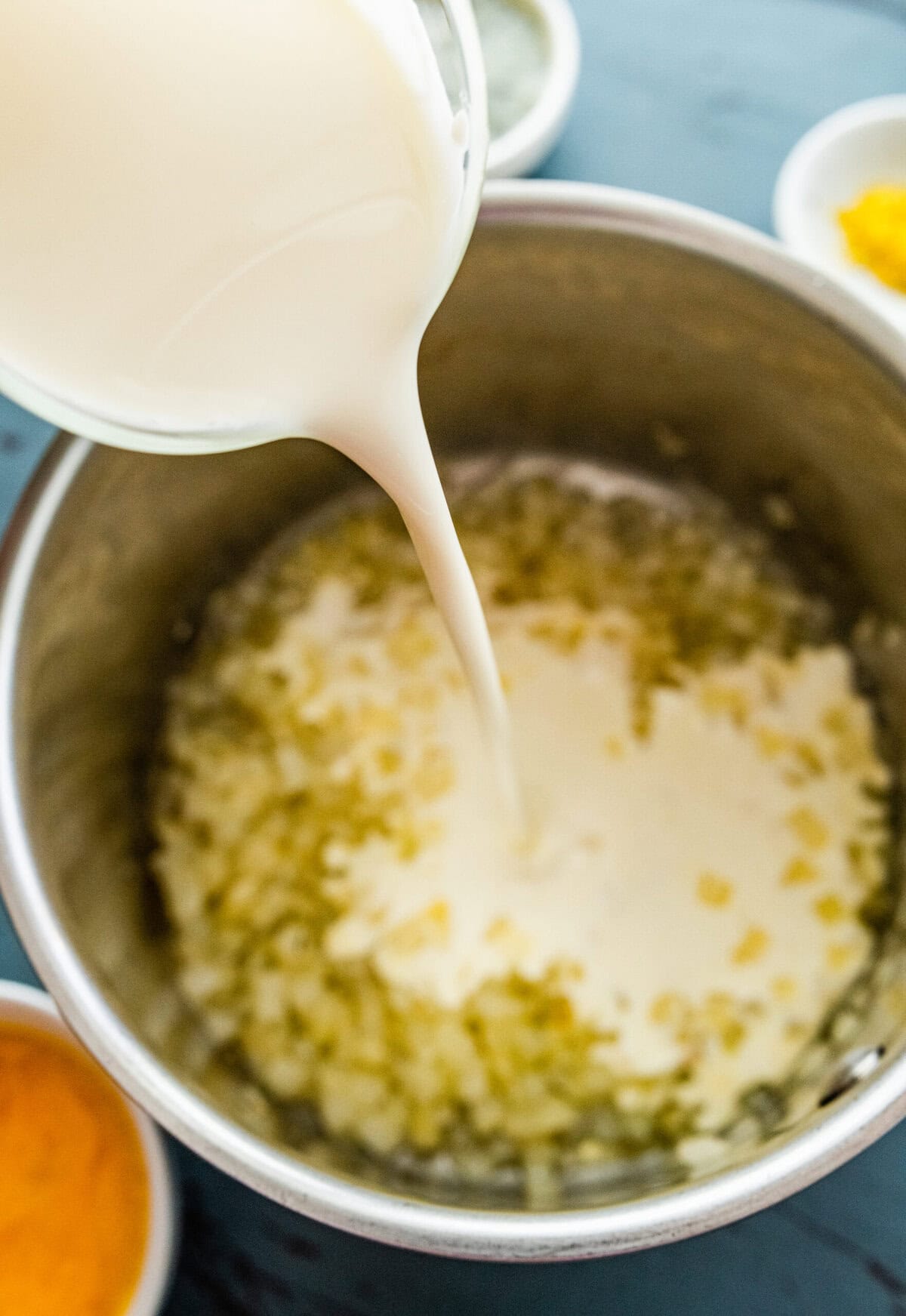 heavy cream and onion cooking in a pot.