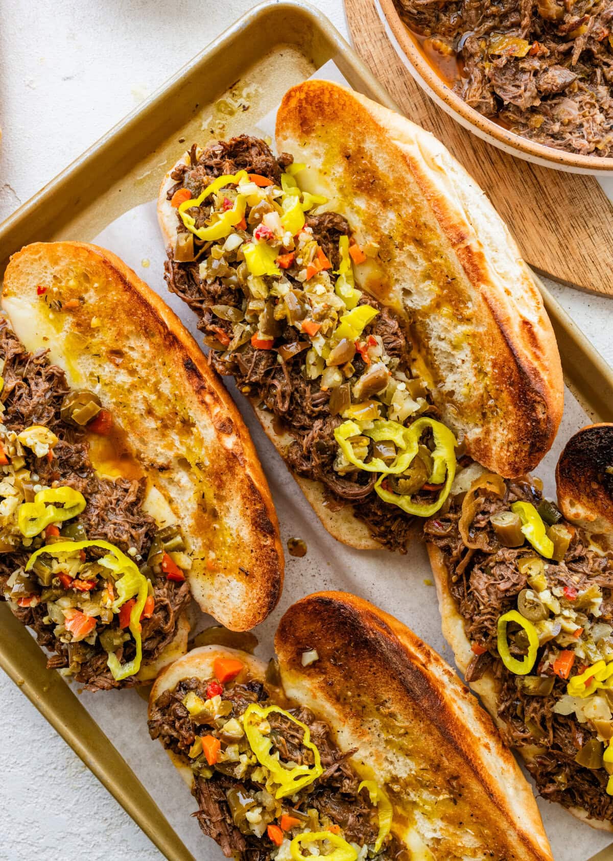 Italian beef recipe made into sandwiches on toasted buns with cheese.