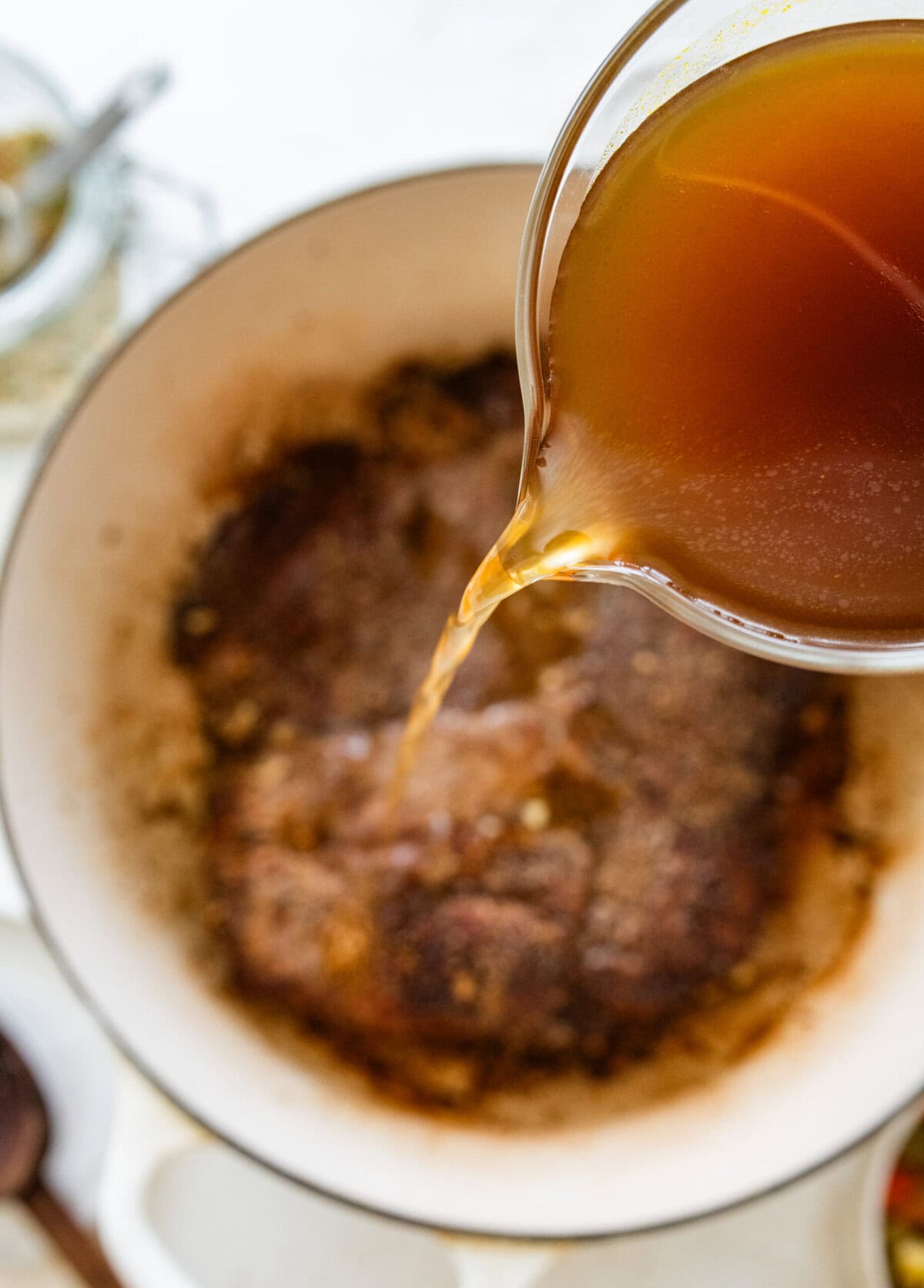 Add liquid to the seared meat.