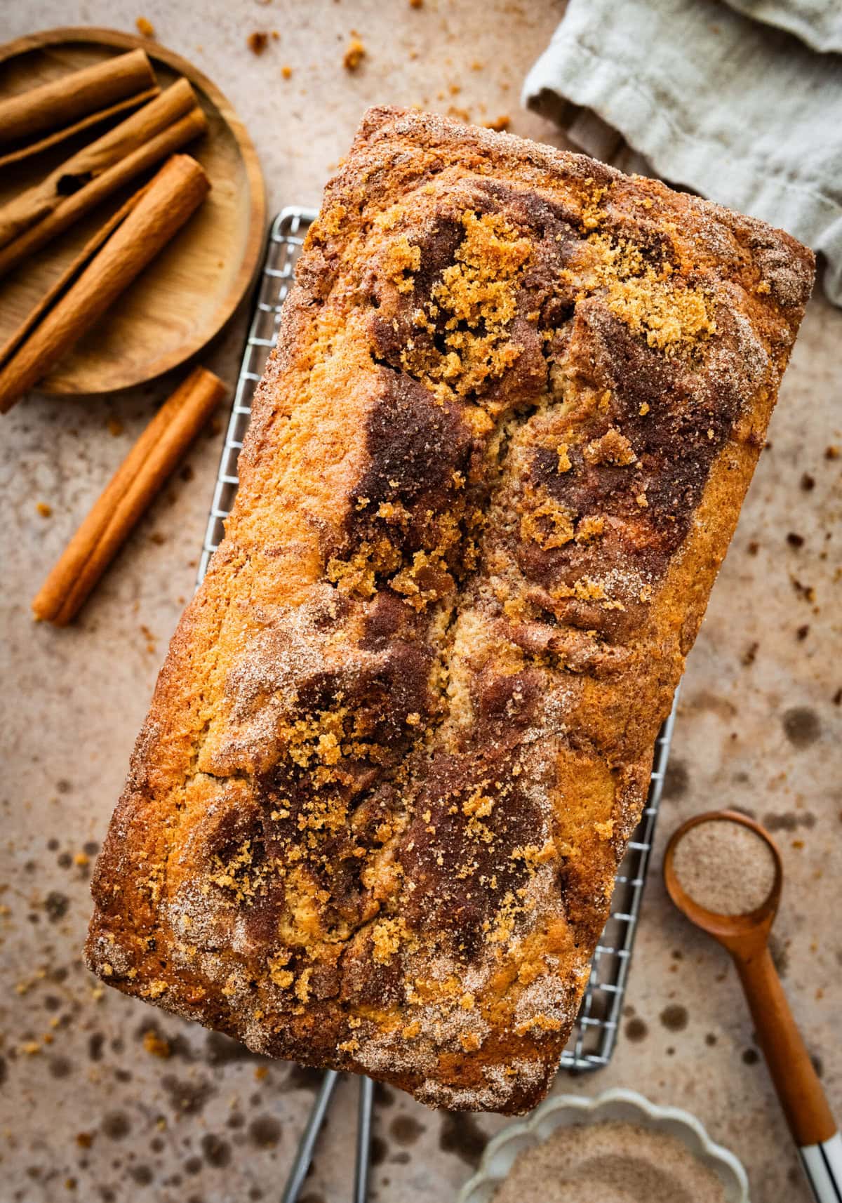 cinnamon swirl bread in pan after baking with golden brown topping.