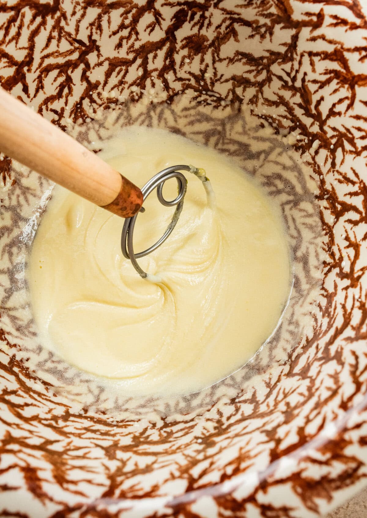 whipped sugar and egg in a bowl with a whisk.