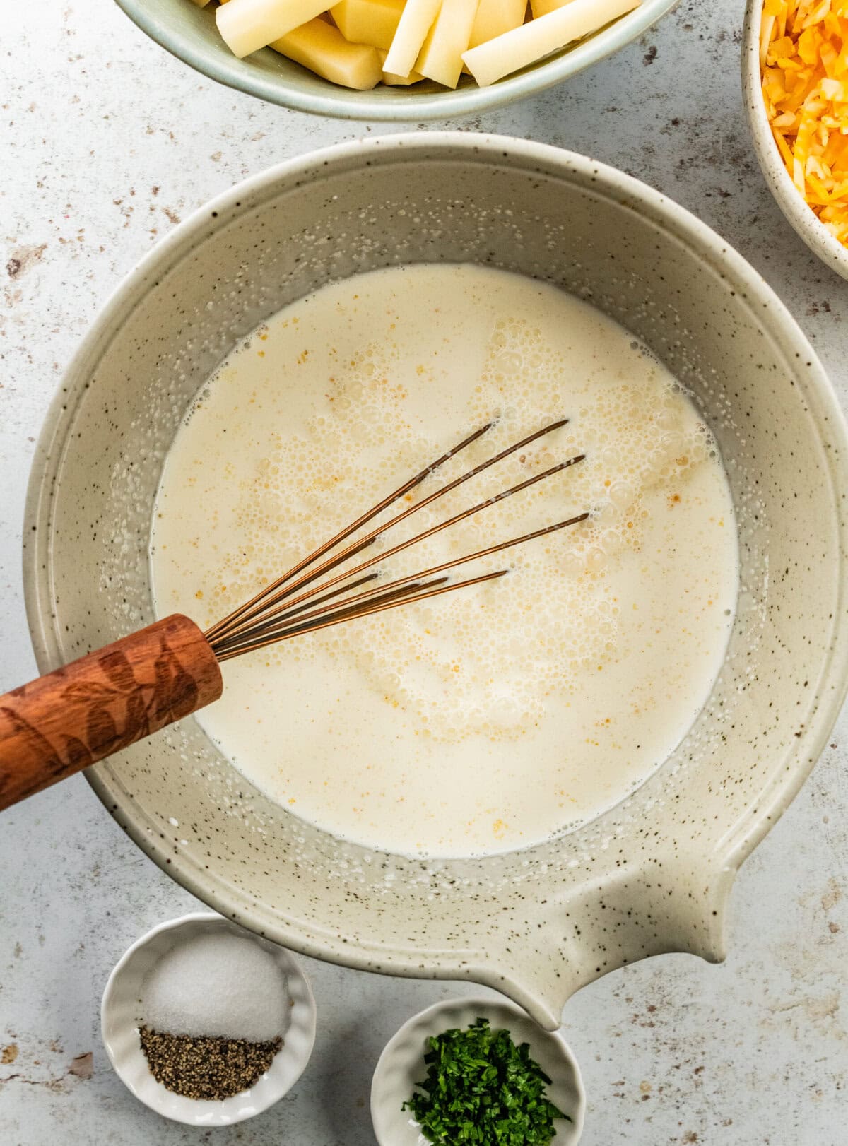 whisk in the bowl of cream for the cheesy potatoes.