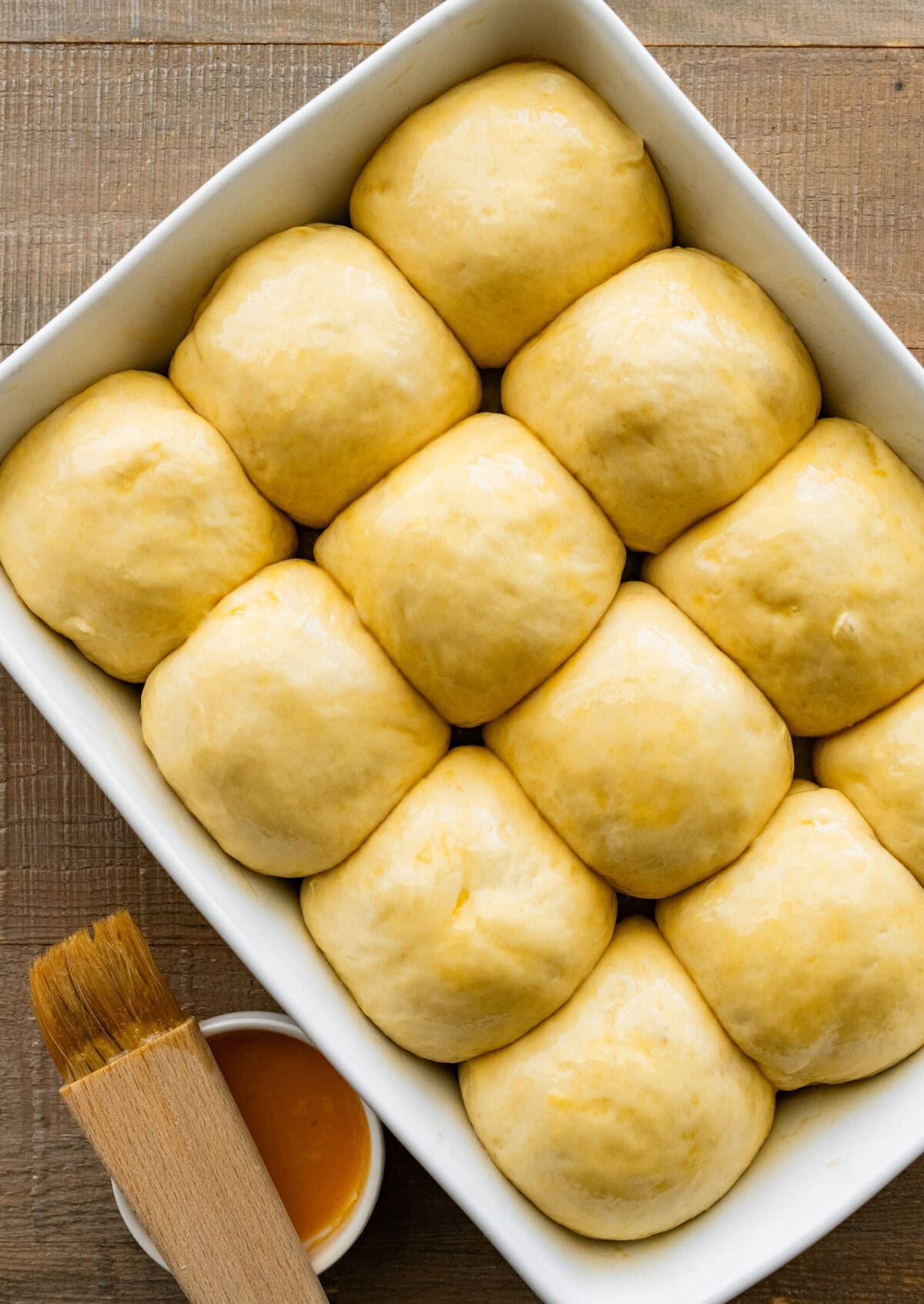 dinner rolls before baking with brushed butter on the top.