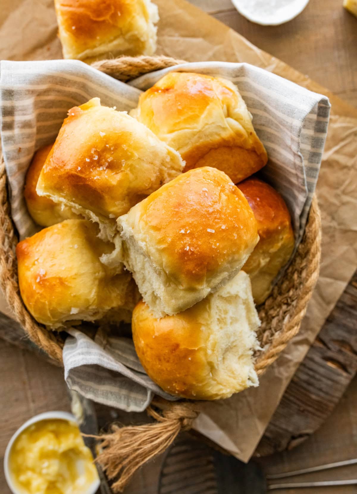 soft and fluffy dinner rolls with golden brown tops in a bread basket.