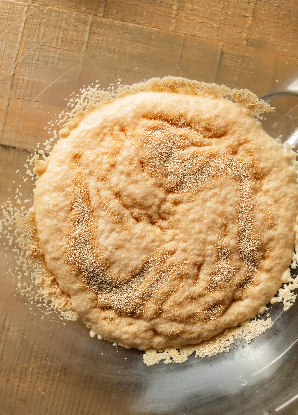 yeast and water after yeast activated in glass mixing bowl.