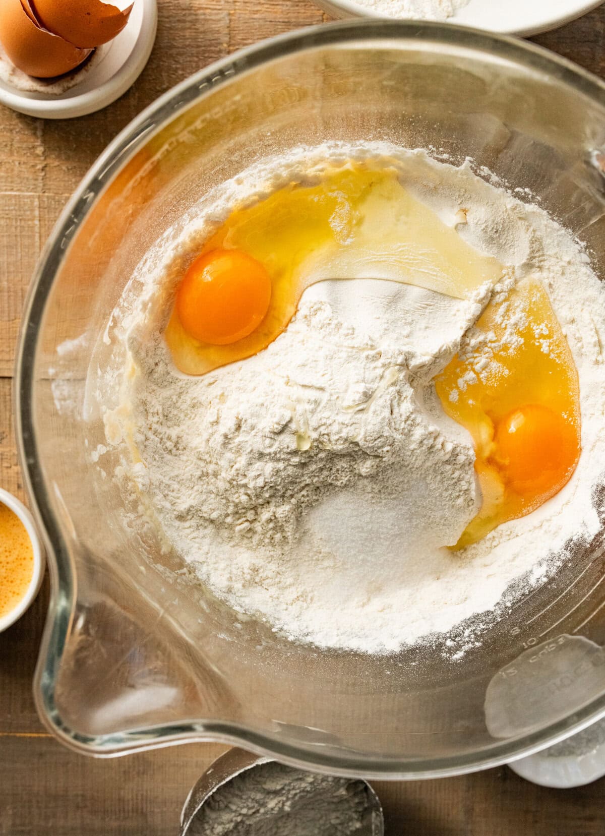 flour and eggs added to glass mixing bowl.