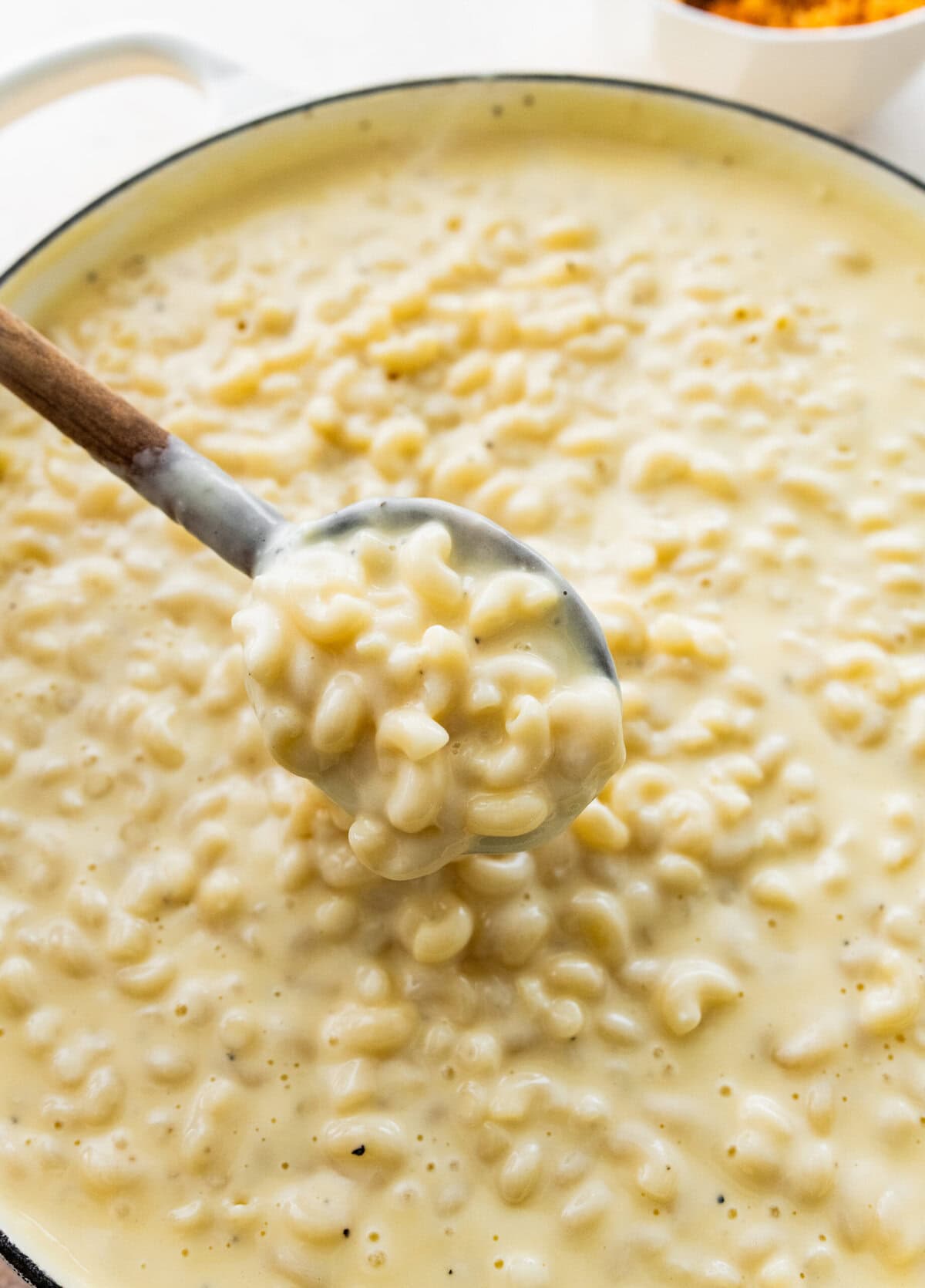 homemade mac and cheese in pot with super cheesy sauce.