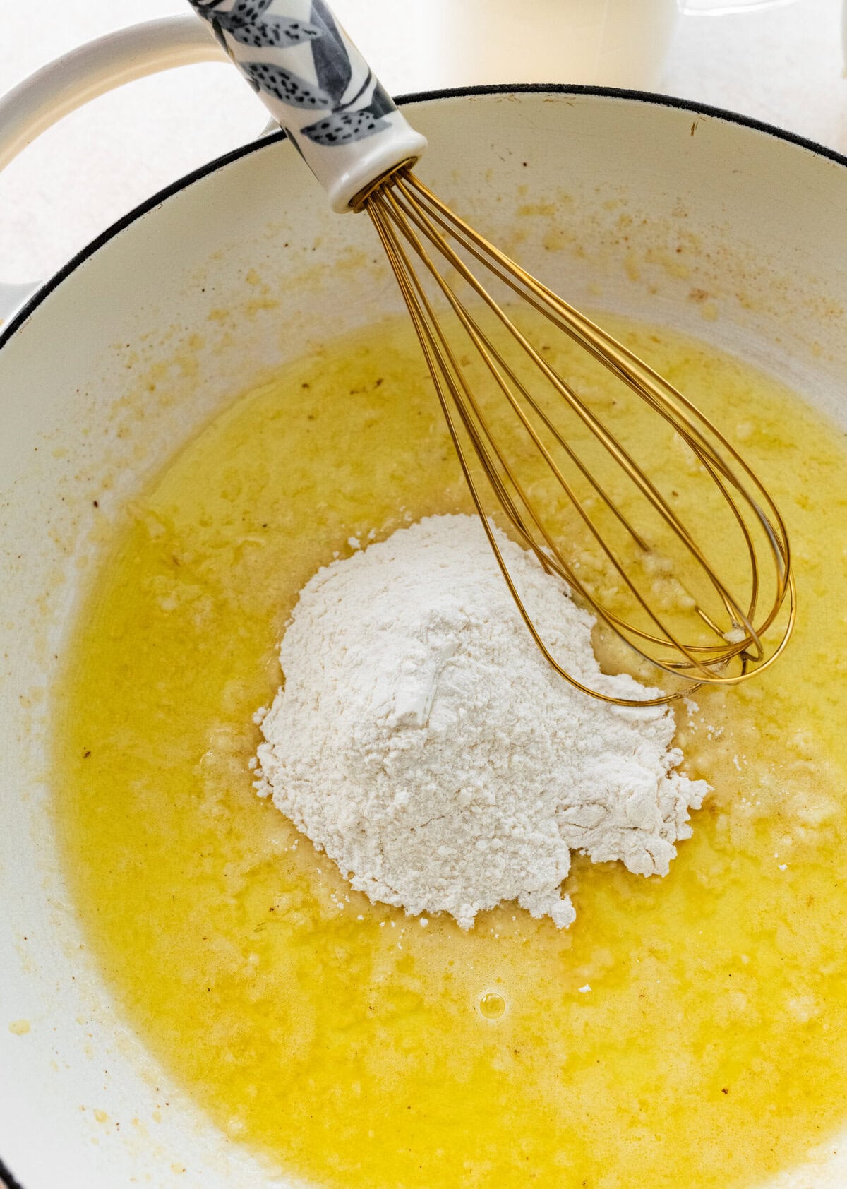 flour, melted butter and garlic in a pan for the homemade mac and cheese recipe.