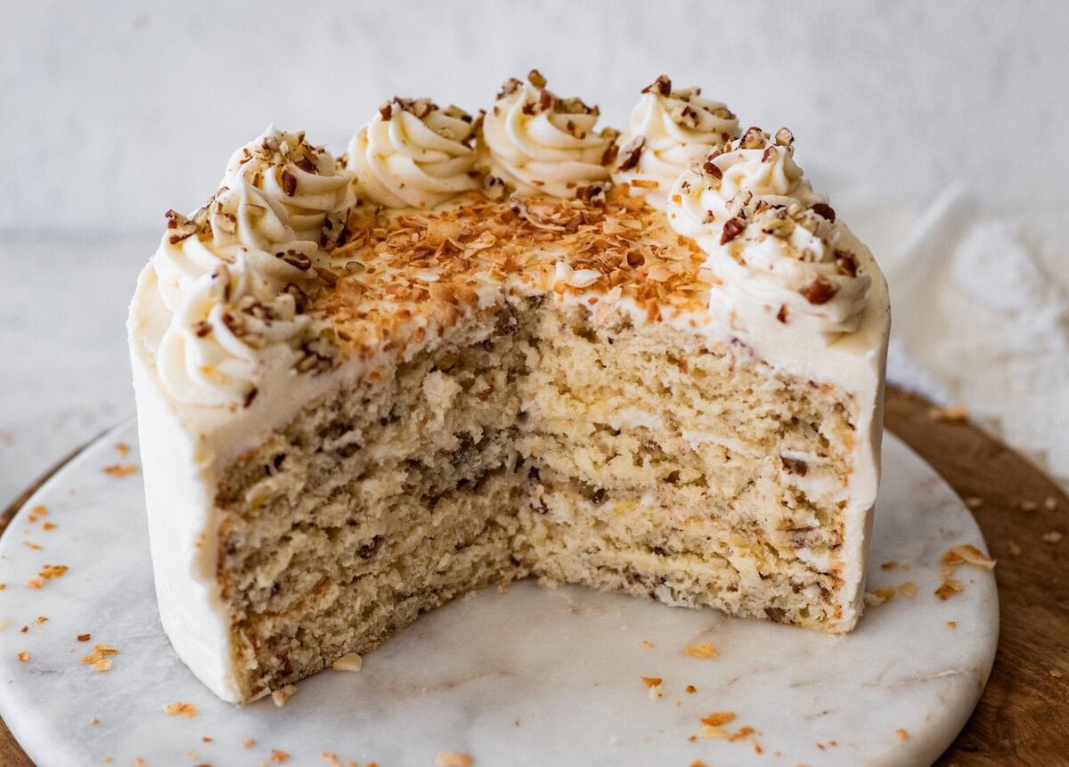 Italian cream cake cut open to see the sft inside and layers of frosting.