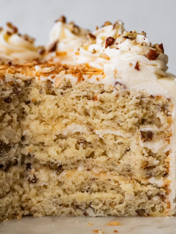 Italian cream cake cut open to see the sft inside and layers of frosting.