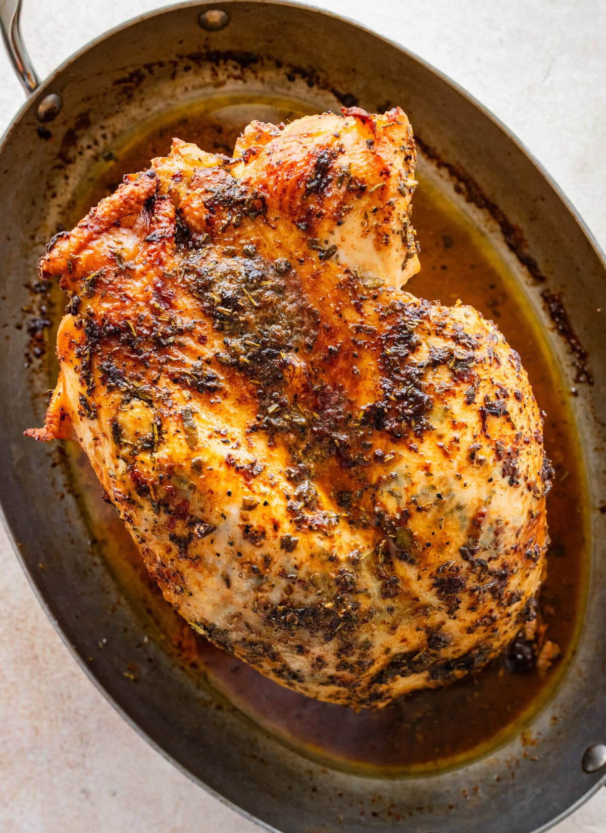 roast turkey breast in a baking pan with a golden brown crust.