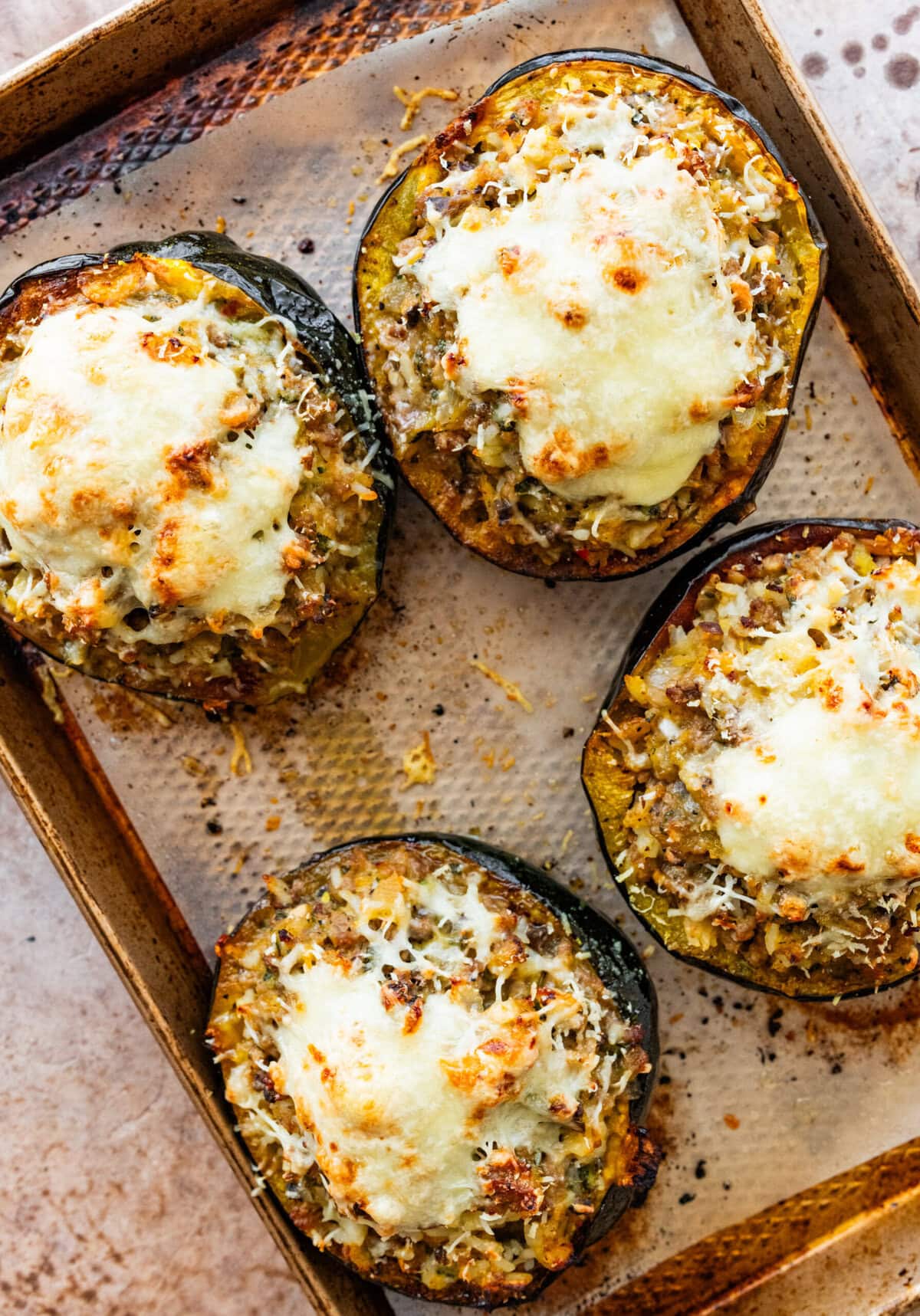 baked stuffed acorn squash with melty cheese on top.