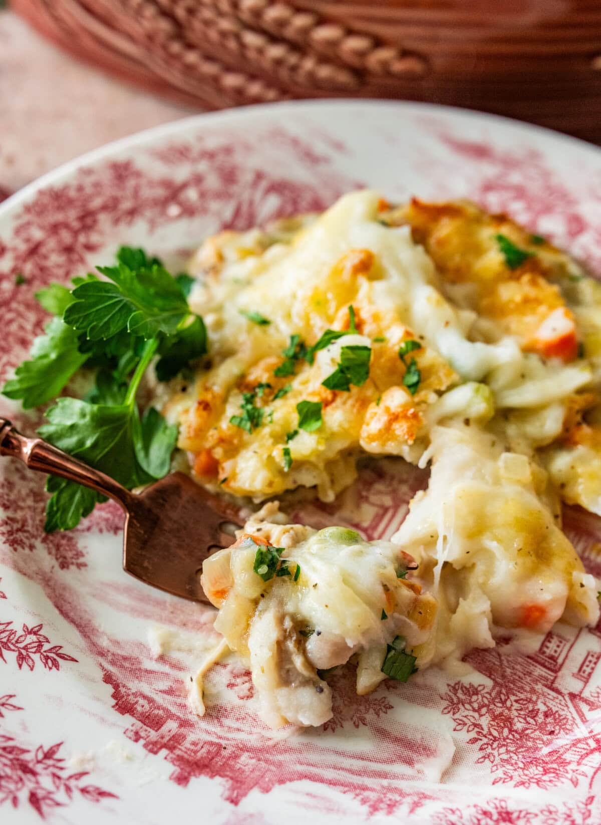 turkey shepards pie on a Thanksgiving plate with a fork taking a bite.