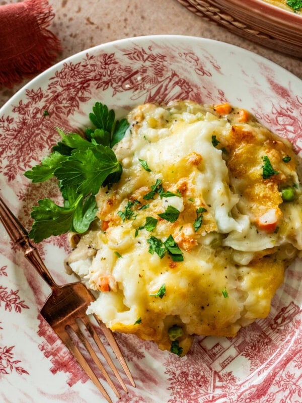 turkey shepards pie on a Thanksgiving plate with a fork taking a bite.