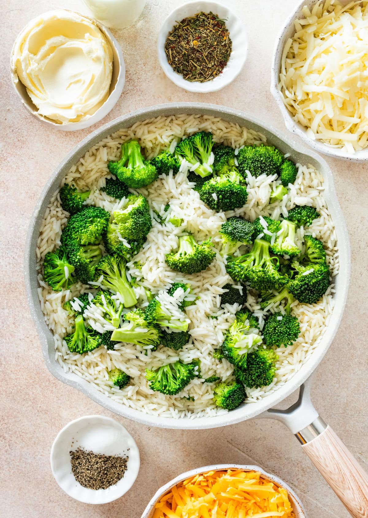 cooked rice and broccoli in a pot.