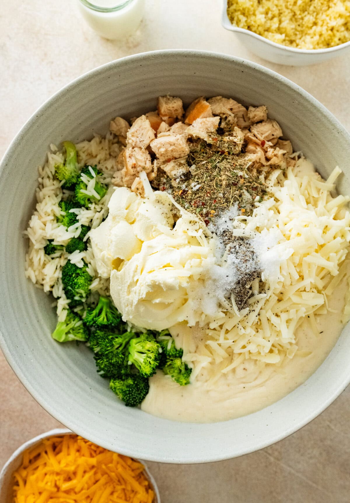 all ingredients for the casserole including the chicken, rice and cheese in a large bowl.