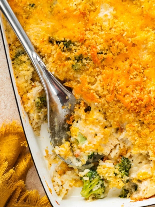 serving spoon with a portion of the chicken broccoli and rice casserole showing delicious layers.