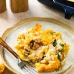 plate of chicken broccoli and rice casserole with a fork ready to eat.