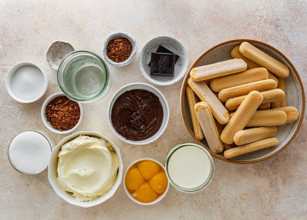 ingredients for chocolate tiramisu on a marble background.