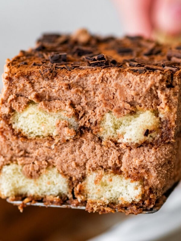 a square slice of chocolate tiramisu with all the layers of chocolate cream showing.