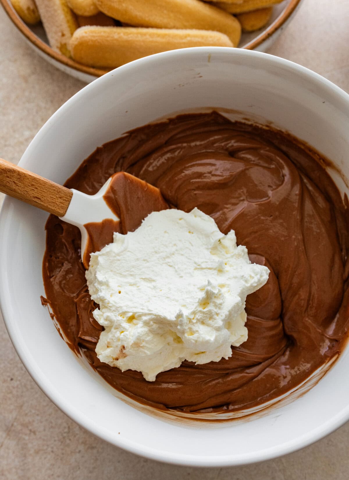 whipped cream in bowl with chocolate custard.