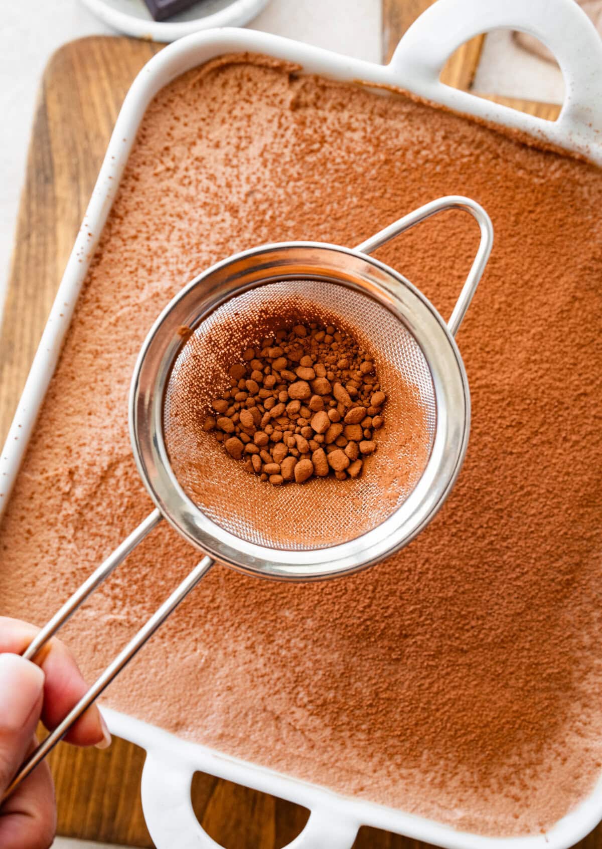 dust the top of the chocolate tiramisu with cocoa powder.