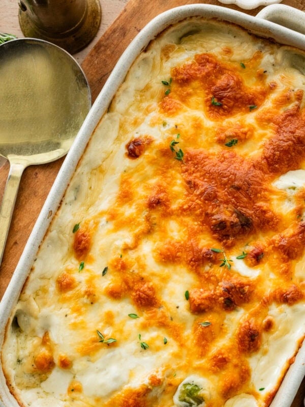 baked creamy brussels sprouts in baking dish with golden brown cheesy topping.
